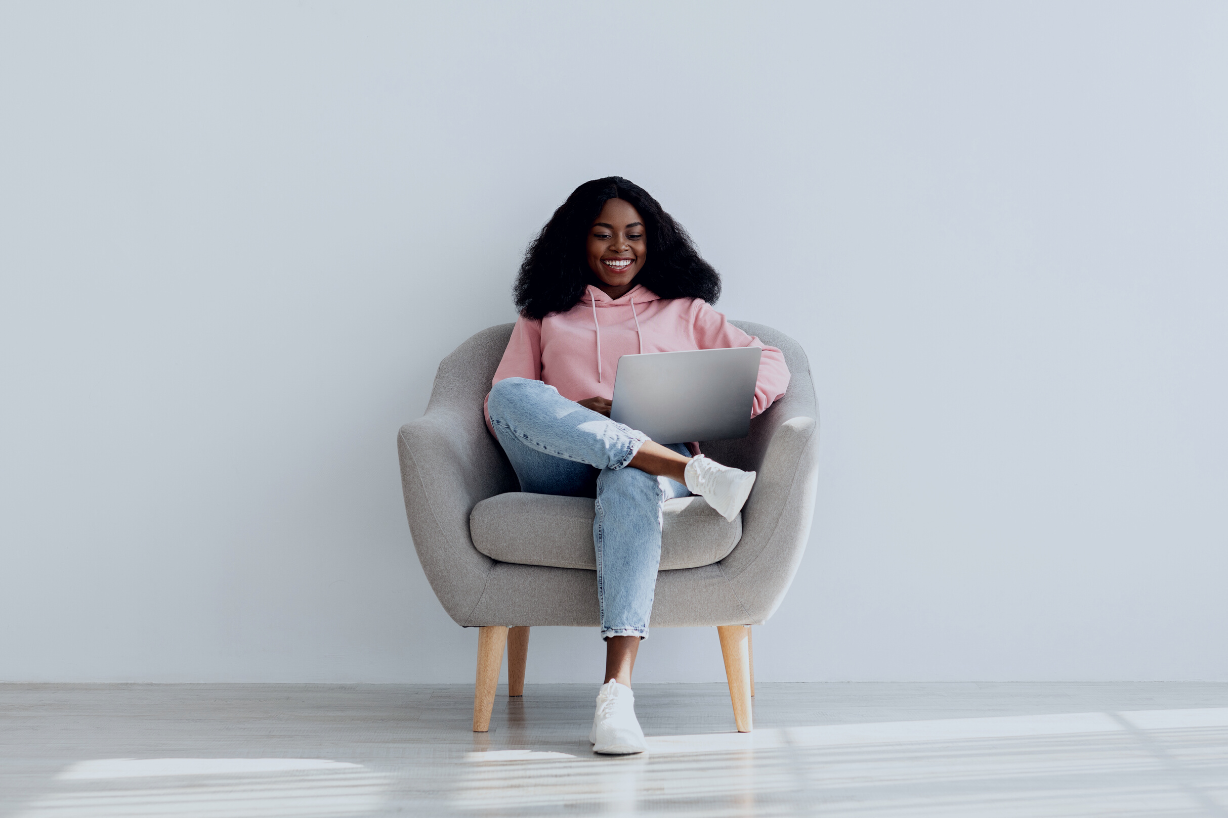 Happy Black Woman Independent Contractor Using Laptop at Home